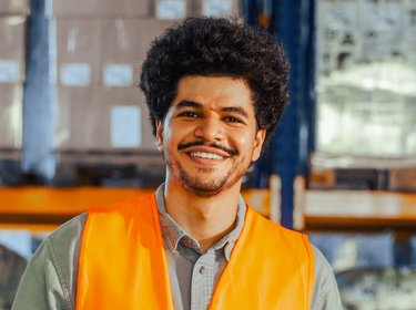 Man in a warehouse smiling